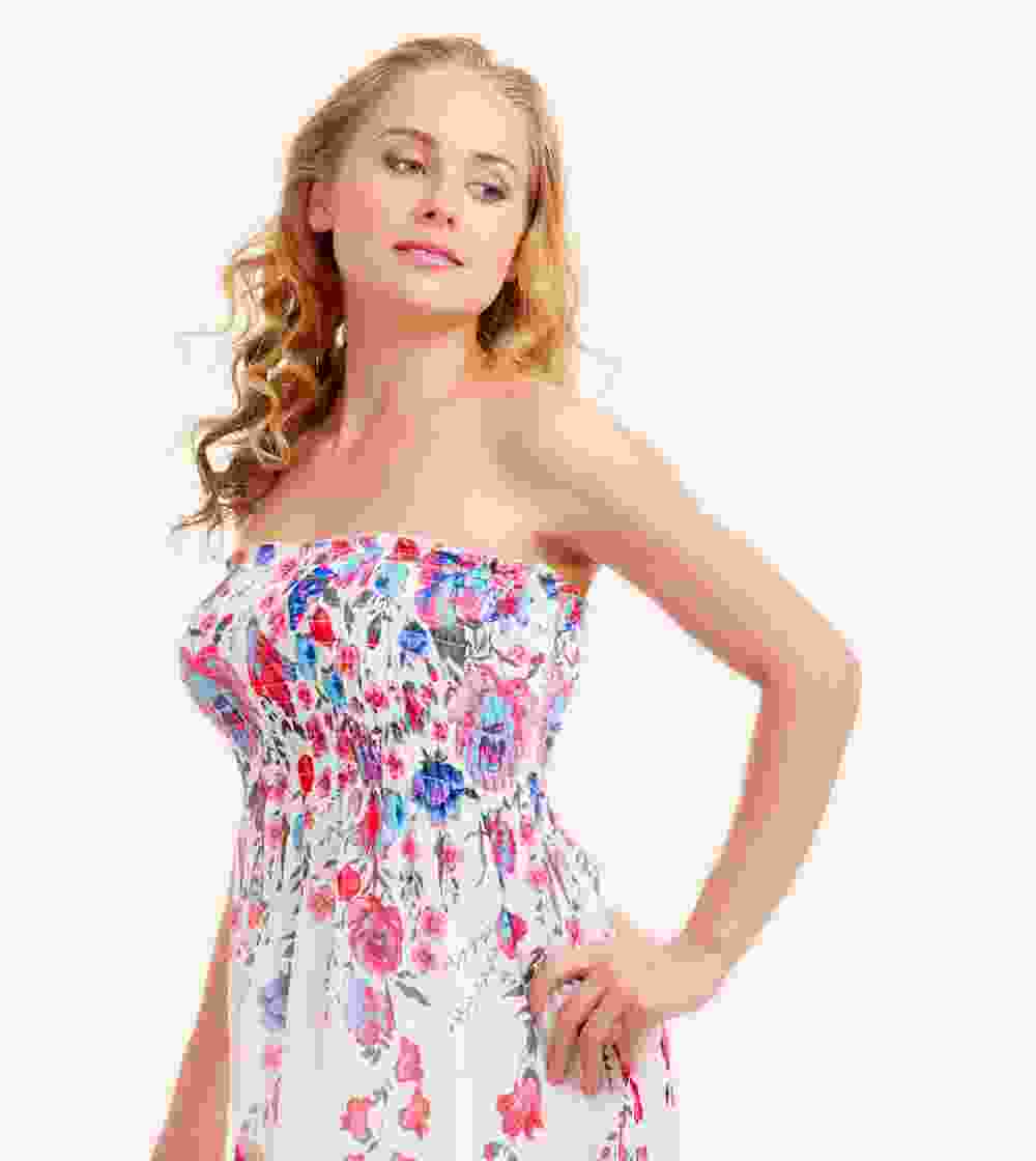 Woman in a strapless floral dress posing confidently.