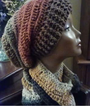 Handmade crocheted hat and scarf displayed on a mannequin head.